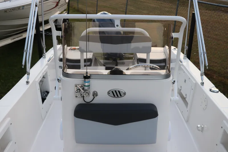 Slide: The Image of 2025 Robalo R160 Center Console boat interior with steering wheel and windshield. - 28