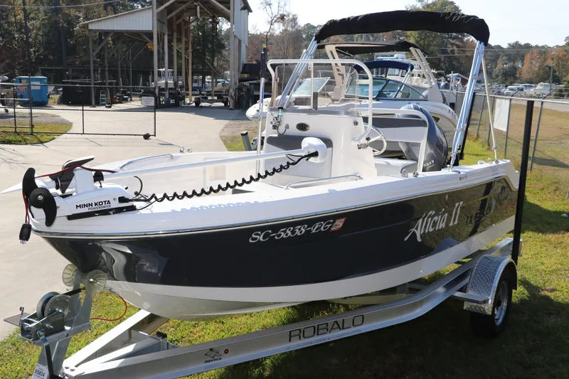 Slide: The Image of 2025 Robalo R160 Center Console boat on trailer, featuring Minn Kota motor. - 3