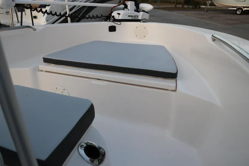 Slide: The Image of 2025 Robalo R160 Center Console boat interior with cushioned seating and Minn Kota trolling motor. - 31