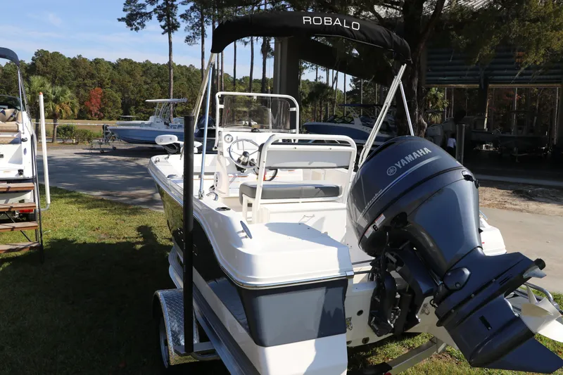 Slide: The Image of 2025 Robalo R160 Center Console boat with Yamaha engine, parked outdoors. - 5