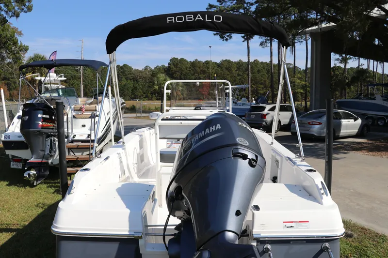 Slide: The Image of 2025 Robalo R160 Center Console boat with Yamaha engine, parked outdoors. - 6