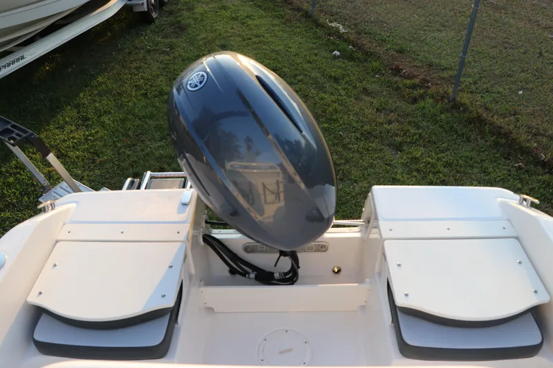 Slide: The Image of 2025 Robalo R160 Center Console boat with outboard motor, rear view. - 8