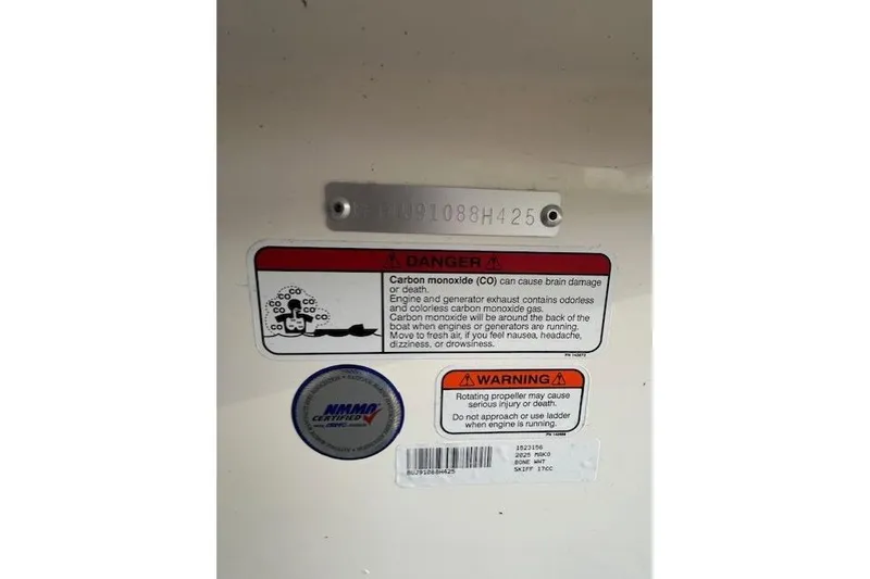 Slide: The Image of Warning labels on 2025 Mako Pro Skiff 17 CC boat, highlighting carbon monoxide and propeller dangers. - 51