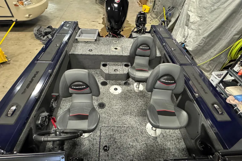Slide: The Image of 2025 Tracker Targa V-19 WT boat interior with four seats and steering wheel. - 16