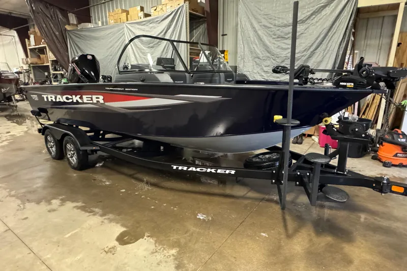 Slide: The Image of 2025 Tracker Targa V-19 WT boat in a garage, on a trailer, side view. - 2