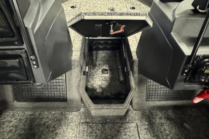 Slide: The Image of 2025 Tracker Targa V-19 WT boat interior with open storage compartment. - 22