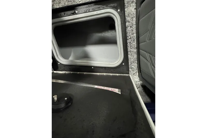 Slide: The Image of Interior view of 2025 Tracker Targa V-19 WT boat, featuring storage compartment and seating. - 24