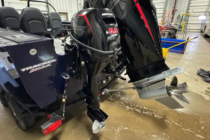 Slide: The Image of 2025 Tracker Targa V-19 WT boat with Mercury outboard motor in a garage setting. - 5