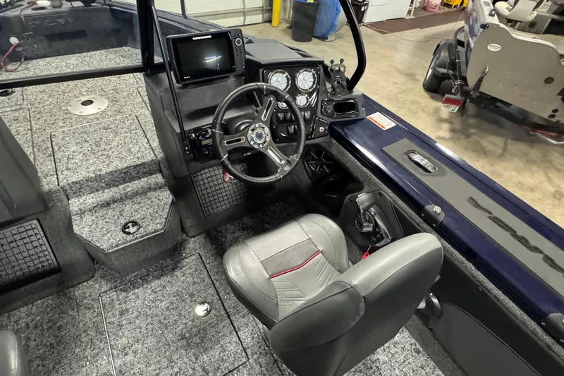 Slide: The Image of 2025 Tracker Targa V-19 WT boat interior with steering wheel and control panel. - 8