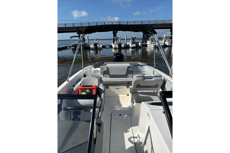 Slide: The Image of 2023 Bayliner VR6 Bowrider OB at marina, featuring spacious seating and sleek design. - 2