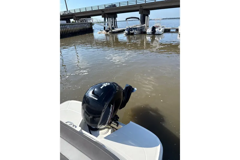 Slide: The Image of 2023 Bayliner VR6 Bowrider OB with Mercury outboard engine at a dock. - 9