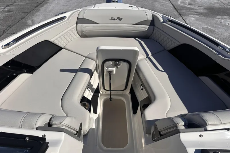 Slide: The Image of 2026 Sea Ray SLX 260 Outboard boat interior with luxurious seating and storage compartment. - 6