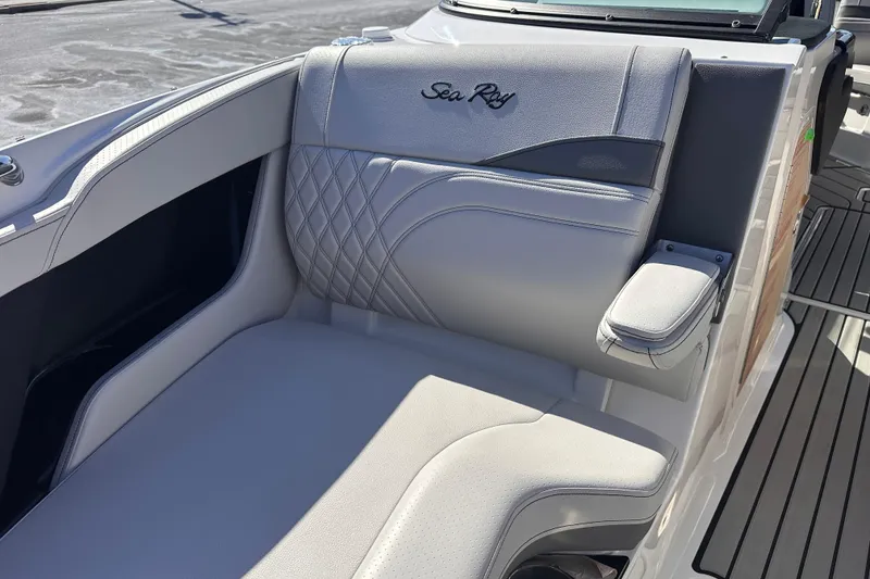 Slide: The Image of 2026 Sea Ray SLX 260 Outboard boat seat with elegant stitching and armrest. - 9