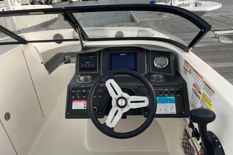 Slide: The Image of 2023 Bayliner VR6 Bowrider OB dashboard with steering wheel and controls. - 5