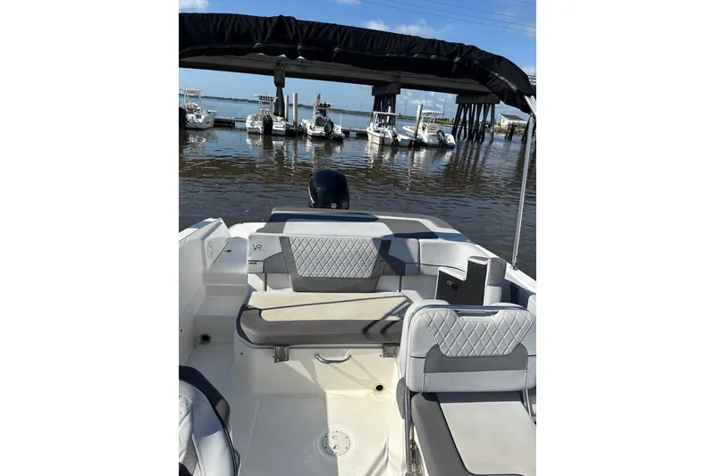 Slide: The Image of 2023 Bayliner VR6 Bowrider OB interior with seating, docked at marina. - 8