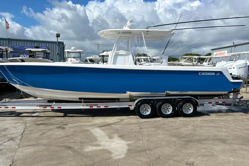 Slide: The Image of 2025 Contender 35 ST boat in blue on a trailer, displayed outdoors. - 1