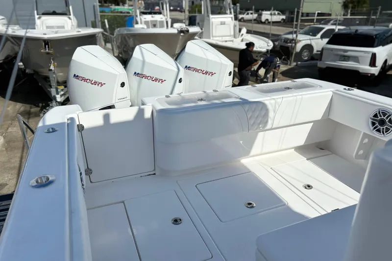 Slide: The Image of 2025 Contender 35 ST boat with triple Mercury engines, docked in a marina. - 10