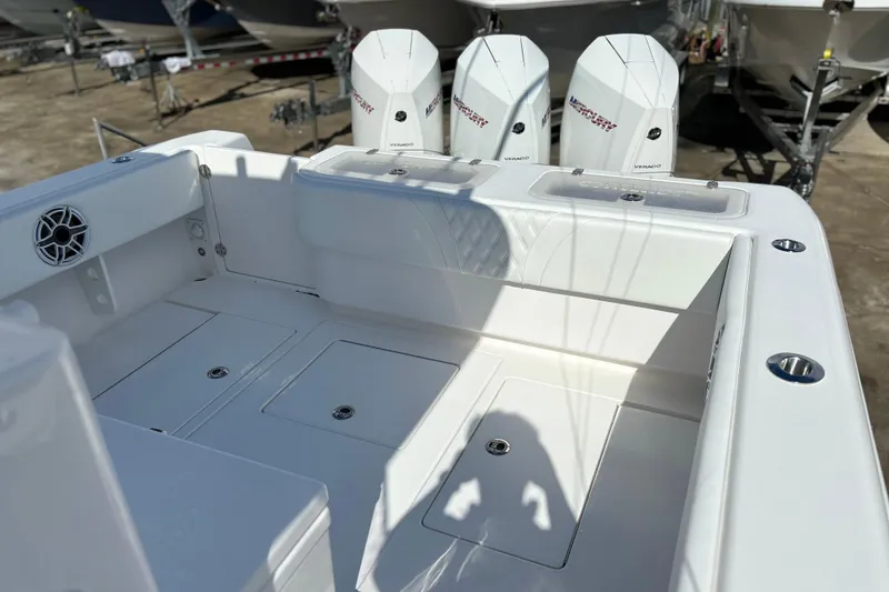 Slide: The Image of 2025 Contender 35 ST boat deck with Mercury Verado engines in a marina setting. - 11