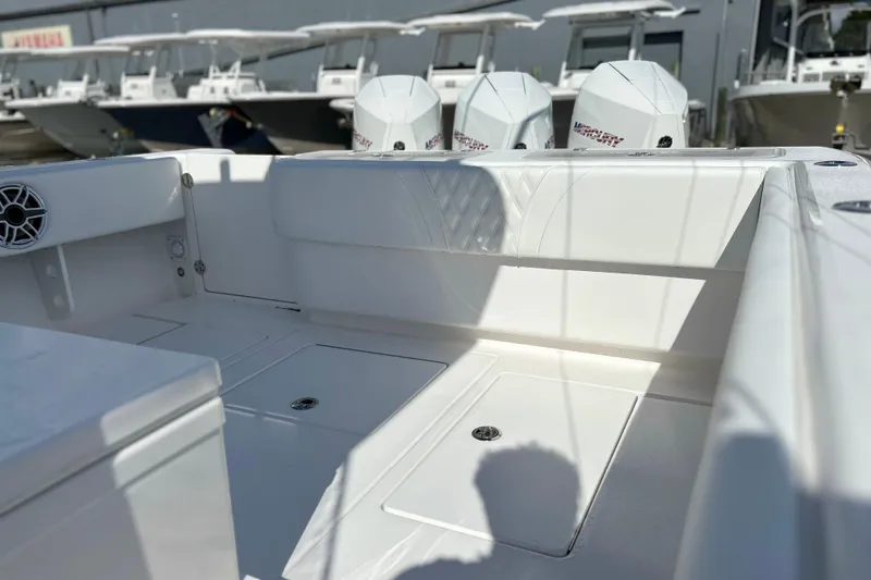 Slide: The Image of 2025 Contender 35 ST boat interior with Mercury engines, showcasing sleek seating and storage. - 14