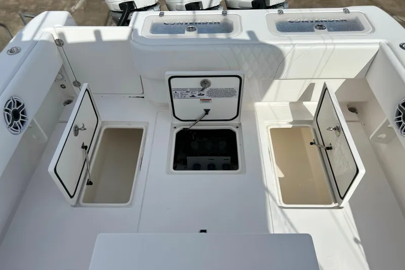 Slide: The Image of 2025 Contender 35 ST boat deck with open storage compartments and speakers. - 25