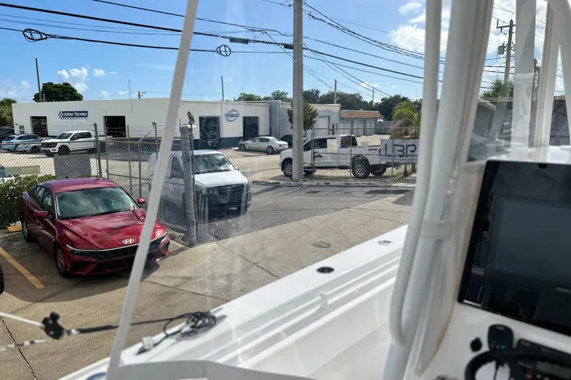 Slide: The Image of View from 2025 Contender 35 ST boat, overlooking parked cars and a service center. - 31