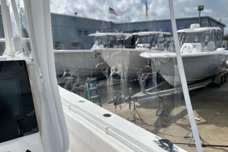 Slide: The Image of 2025 Contender 35 ST boats displayed at a dealership, showcasing sleek design and modern features. - 32