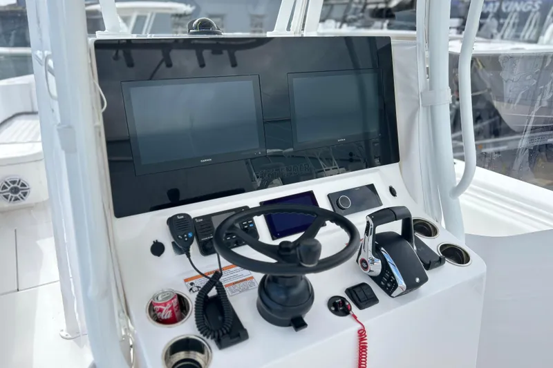 Slide: The Image of 2025 Contender 35 ST boat helm with dual screens and steering wheel. - 34