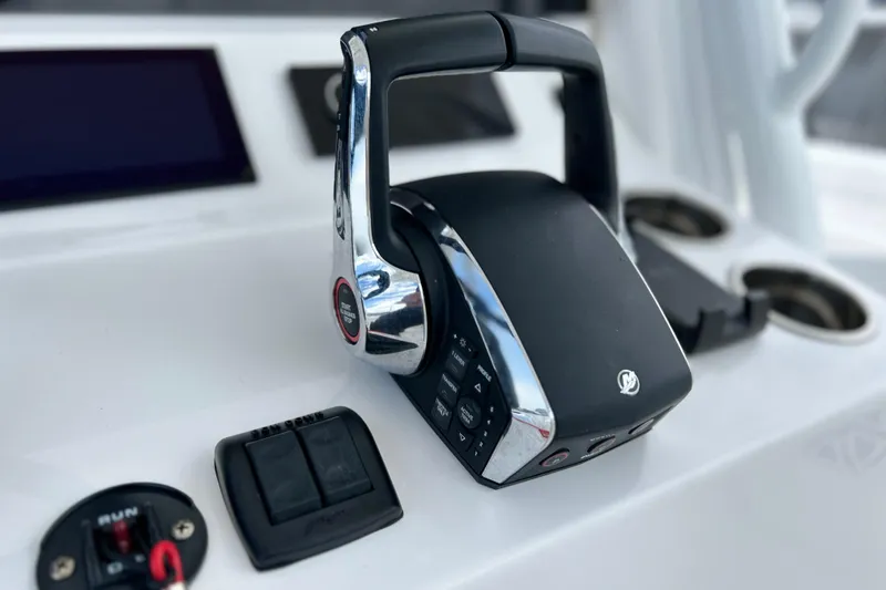 Slide: The Image of 2025 Contender 35 ST boat throttle control on sleek dashboard. - 35
