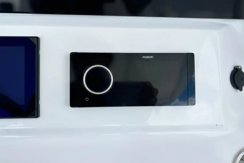 Slide: The Image of Control panel of 2025 Contender 35 ST boat featuring Fusion audio system. - 36
