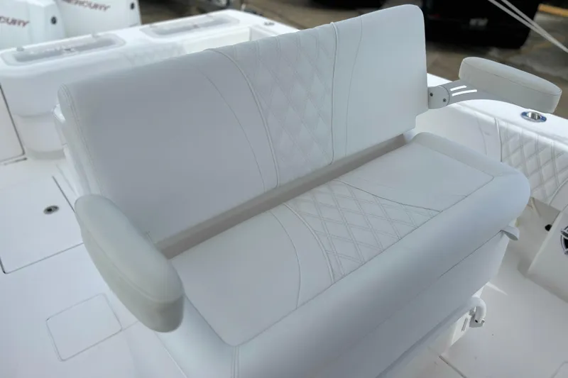 Slide: The Image of White cushioned seating on 2025 Contender 35 ST boat, featuring diamond stitching and armrests. - 38