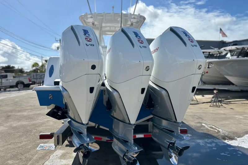 Slide: The Image of 2025 Contender 35 ST boat with triple V8 outboard engines on a sunny day. - 4