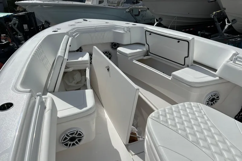 Slide: The Image of 2025 Contender 35 ST boat interior with white seating and storage compartments. - 49