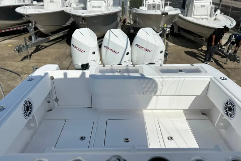 Slide: The Image of 2025 Contender 35 ST boat with triple Mercury engines, docked in a marina. - 9