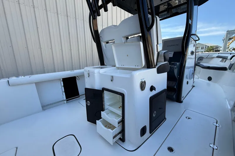 Slide: The Image of 2022 Tidewater 292 CC Adventure boat in marina, showcasing sleek design and modern features. - 11