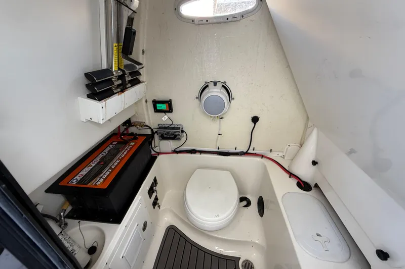 Slide: The Image of 2022 Tidewater 292 CC Adventure boat with dual engines in a marina setting. - 16