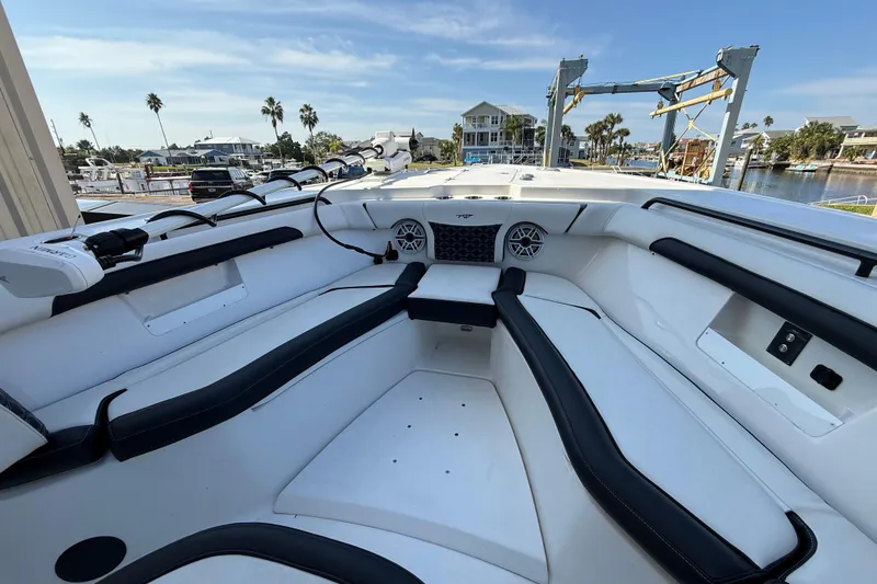 Slide: The Image of 2022 Tidewater 292 CC Adventure boat interior with fresh water access and seating. - 20