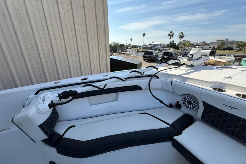 Slide: The Image of 2022 Tidewater 292 CC Adventure boat with luxurious dual seating in a marina setting. - 22