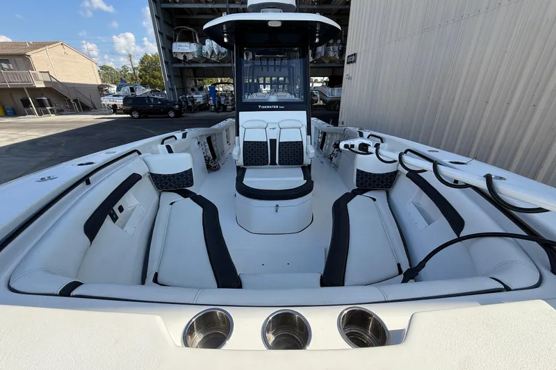 Slide: The Image of 2022 Tidewater 292 CC Adventure boat dashboard with Garmin displays and steering wheel. - 23