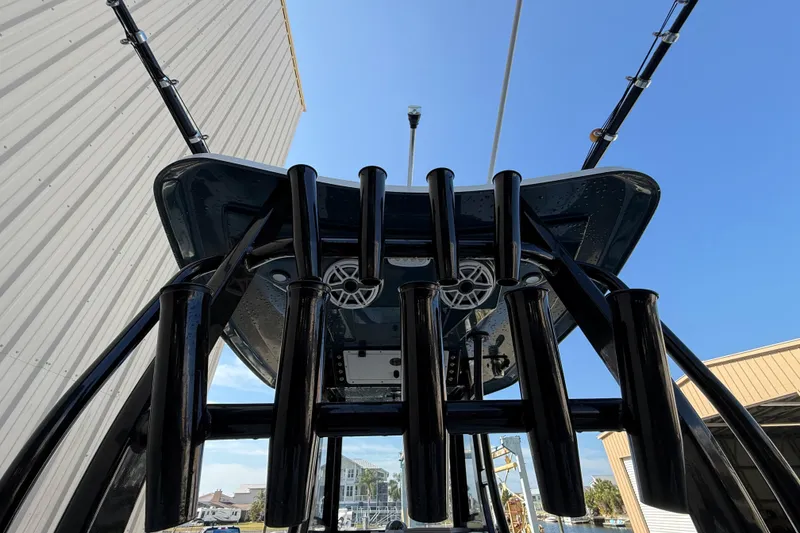 Slide: The Image of 2022 Tidewater 292 CC Adventure boat interior with seating and storage, docked outdoors. - 31