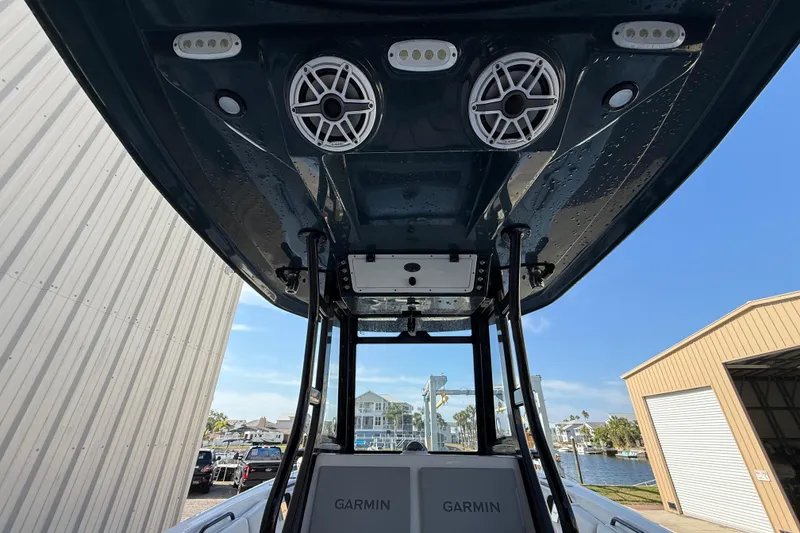 Slide: The Image of 2022 Tidewater 292 CC Adventure boat with rod holders and T-top, viewed from below. - 39