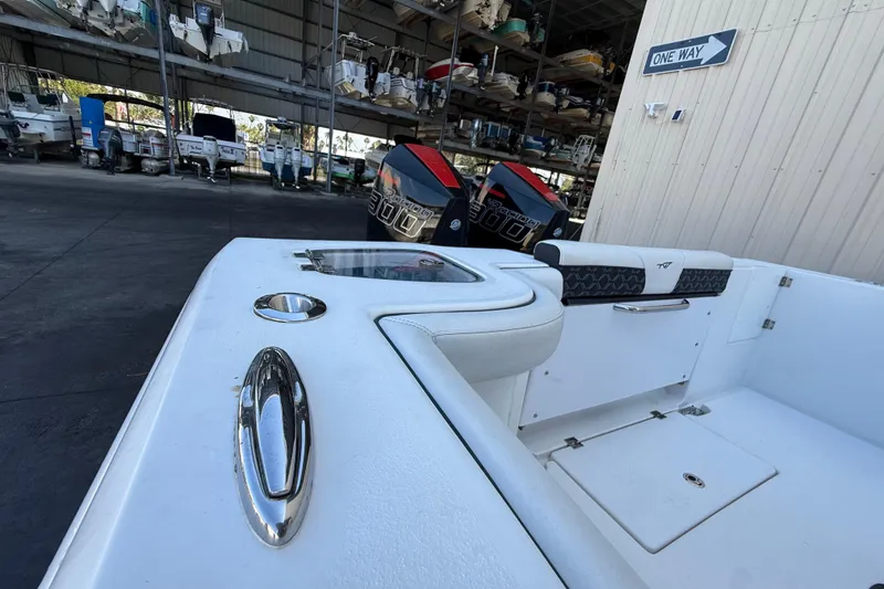 Slide: The Image of 2022 Tidewater 292 CC Adventure boat in storage, featuring sleek design and powerful engines. - 46