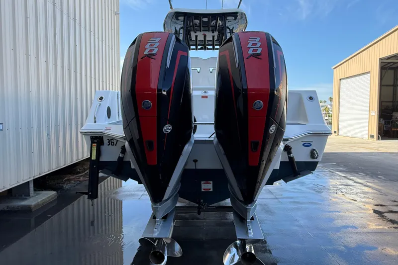 Slide: The Image of 2022 Tidewater 292 CC Adventure boat with dual engines in shallow water. - 5