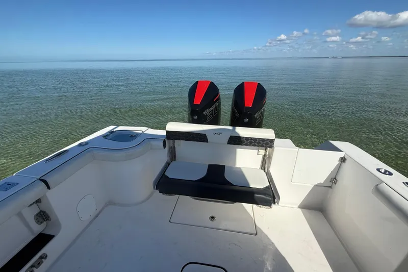 Slide: The Image of 2022 Tidewater 292 CC Adventure boat with dual engines on calm water. - 51