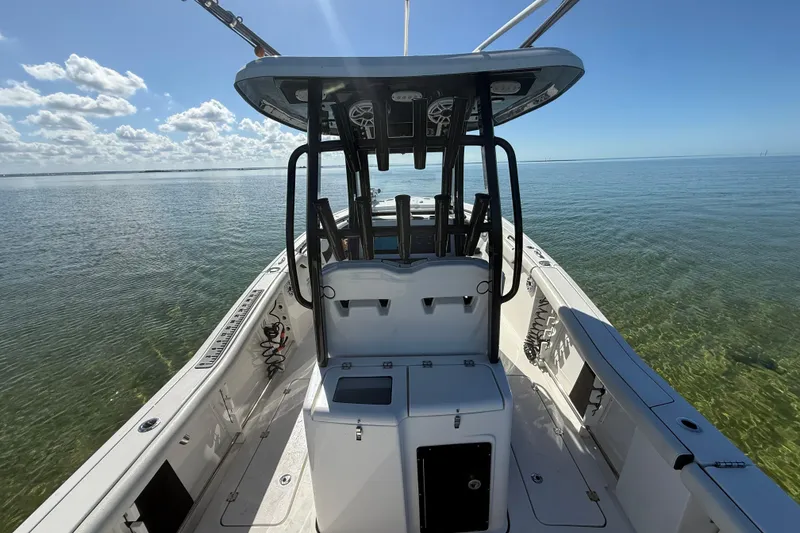 Slide: The Image of 2022 Tidewater 292 CC Adventure boat on calm water under clear blue sky. - 52