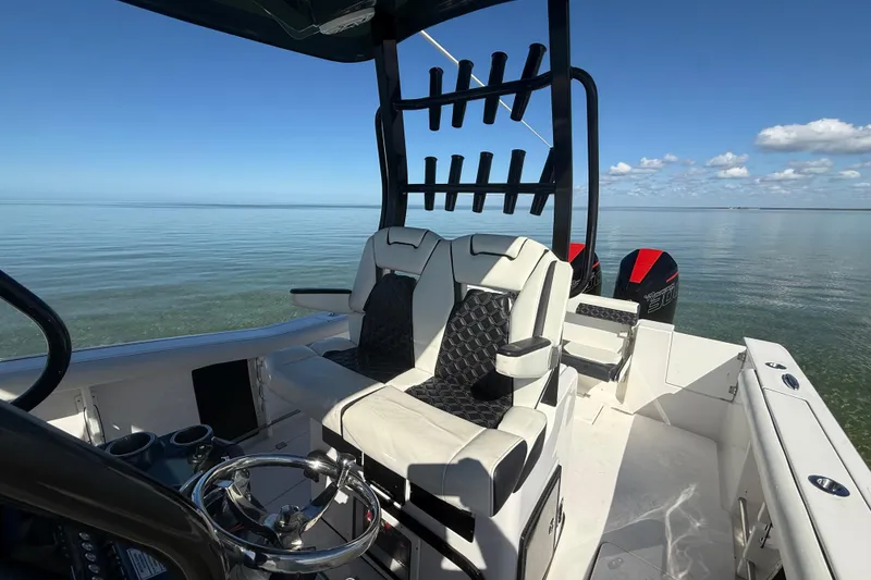 Slide: The Image of 2022 Tidewater 292 CC Adventure boat interior with dual seats and ocean view. - 53