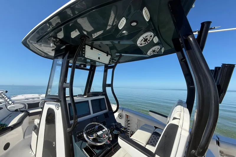 Slide: The Image of 2022 Tidewater 292 CC Adventure boat interior with modern helm and ocean view. - 54
