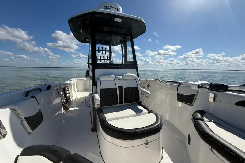 Slide: The Image of 2022 Tidewater 292 CC Adventure boat interior with seating, under a clear blue sky. - 56