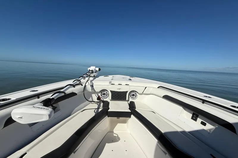 Slide: The Image of 2022 Tidewater 292 CC Adventure boat on calm ocean waters under clear blue sky. - 58