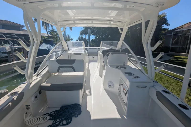 Slide: The Image of 2021 World Cat 280 DC-X boat interior with seating and fishing rod holders. - 13