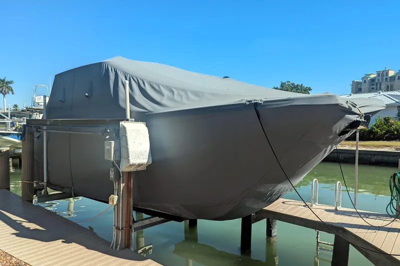 Slide: The Image of 2021 World Cat 280 DC-X boat covered and docked in a sunny marina. - 3
